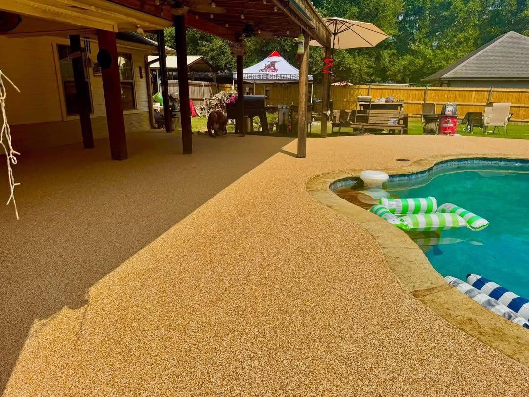 Finished covered pergola patio with tan speckled Pro-Flex surfacing next to the pool