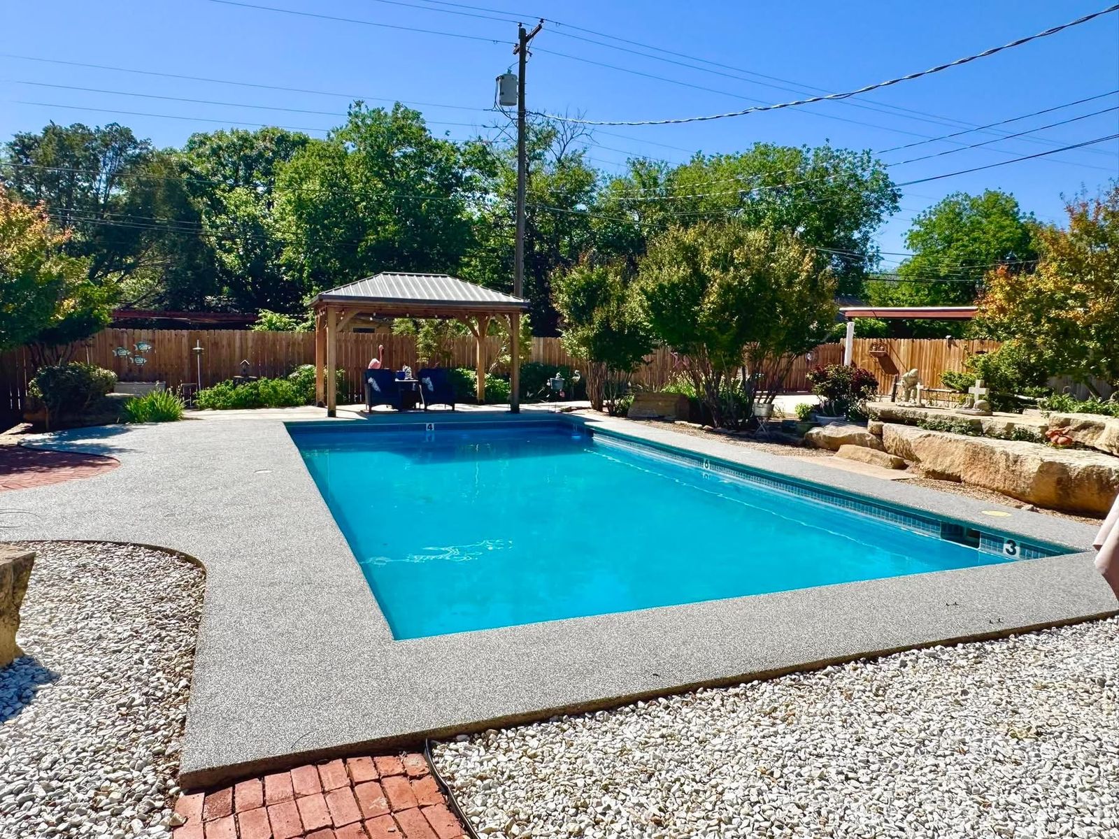 Finished backyard pool deck with a gazebo and tan speckled Pro-Flex surfacing