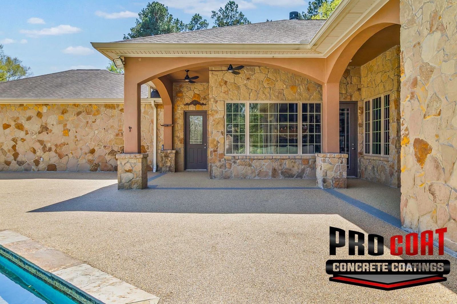 Covered stone patio entry finished in tan speckled flooring