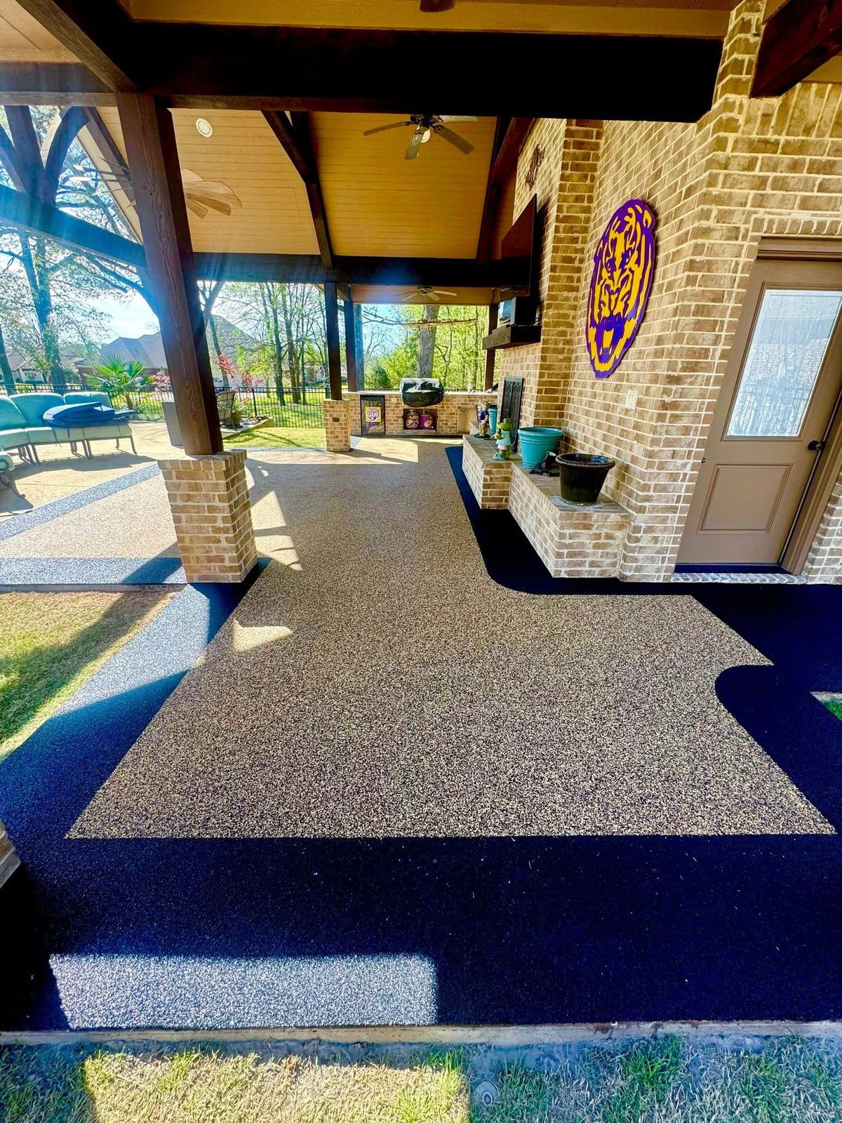 Finished patio surface with a custom decorative logo inlay