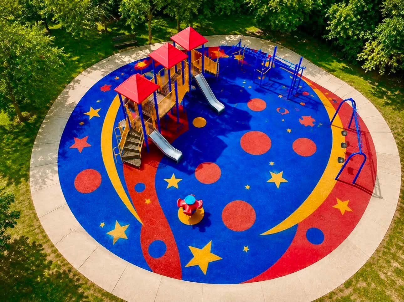 Aerial view of a commercial playground finished with custom red, blue, and yellow EPDM rubber surfacing