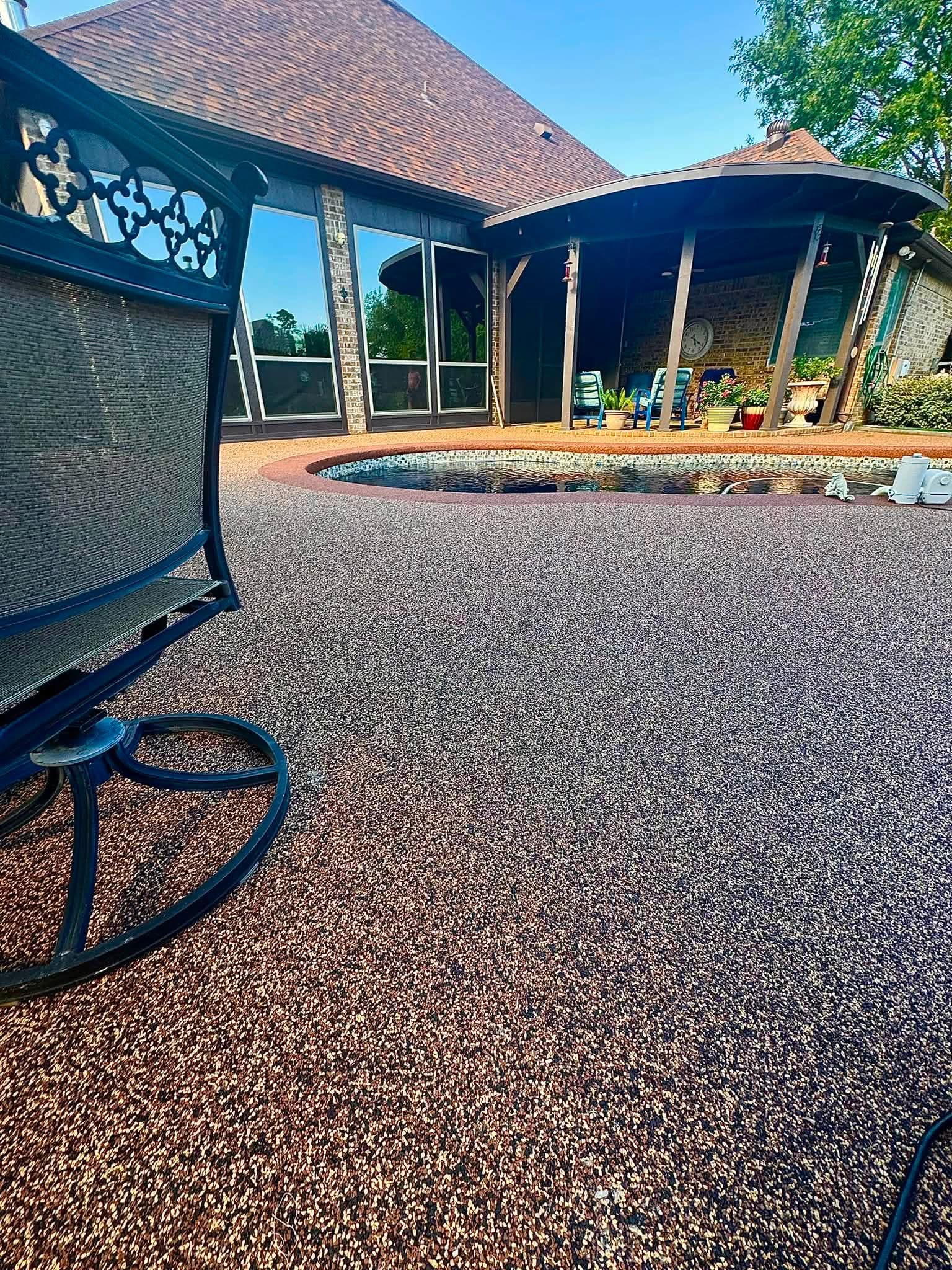 Close-up of tan speckled Pro-Flex deck surfacing beside a small pool