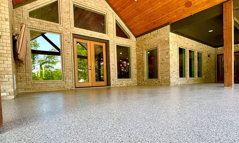 Residential covered patio finished with a gray speckled flake floor coating