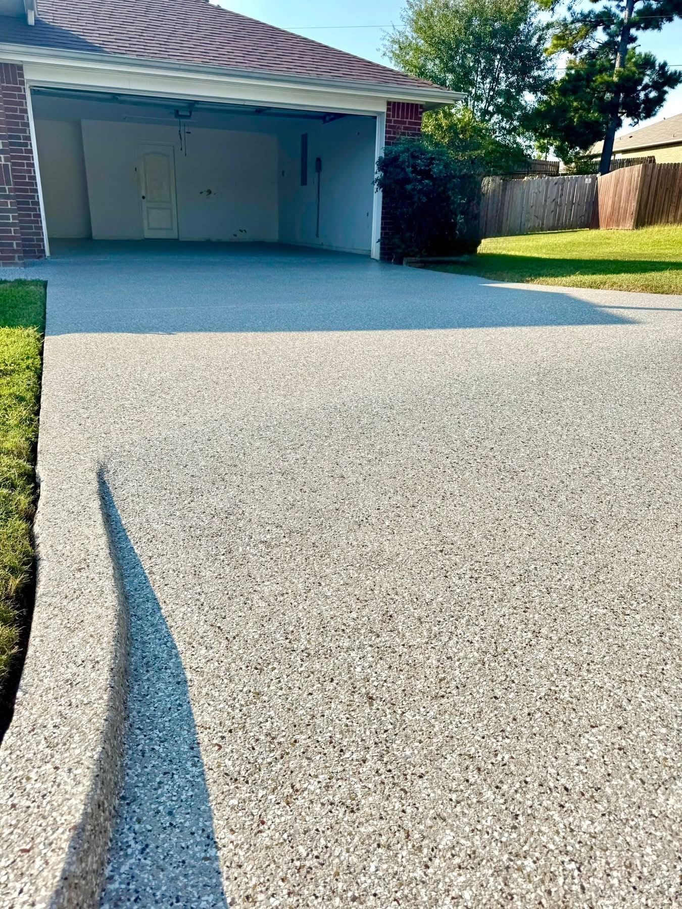 Driveway extension finished with a tan speckled flake floor coating