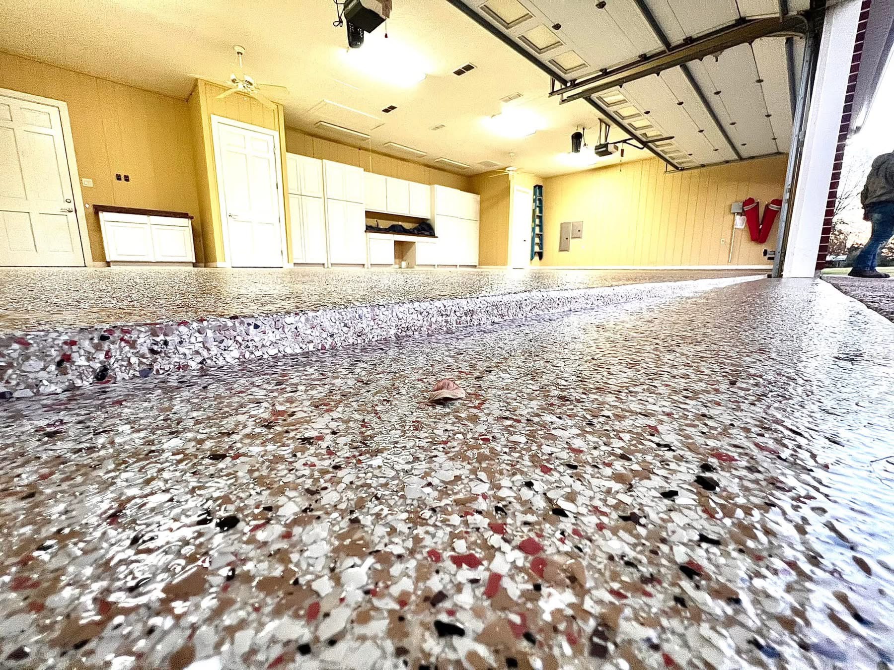 Close-up of a freshly coated speckled flake floor in a commercial warehouse