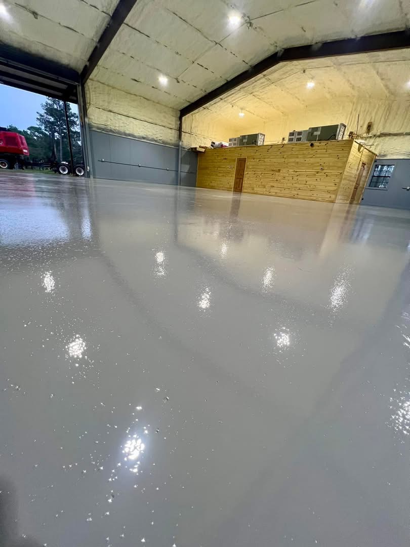 Glossy dark gray flake floor coating finished in a commercial warehouse