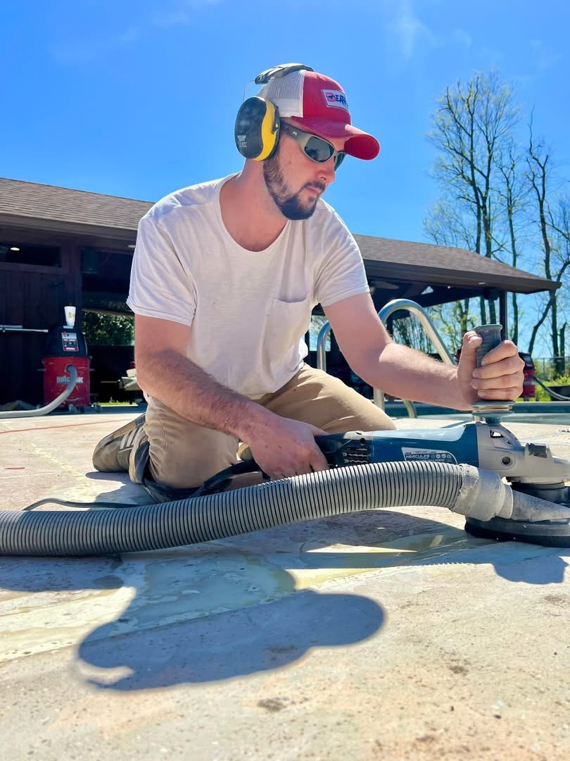 Technician operating diamond grinding equipment during floor preparation