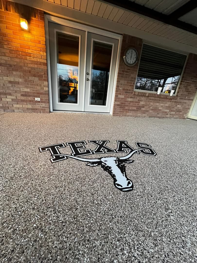 Patio floor finished with a speckled flake coating and a custom Texas longhorn logo inlay