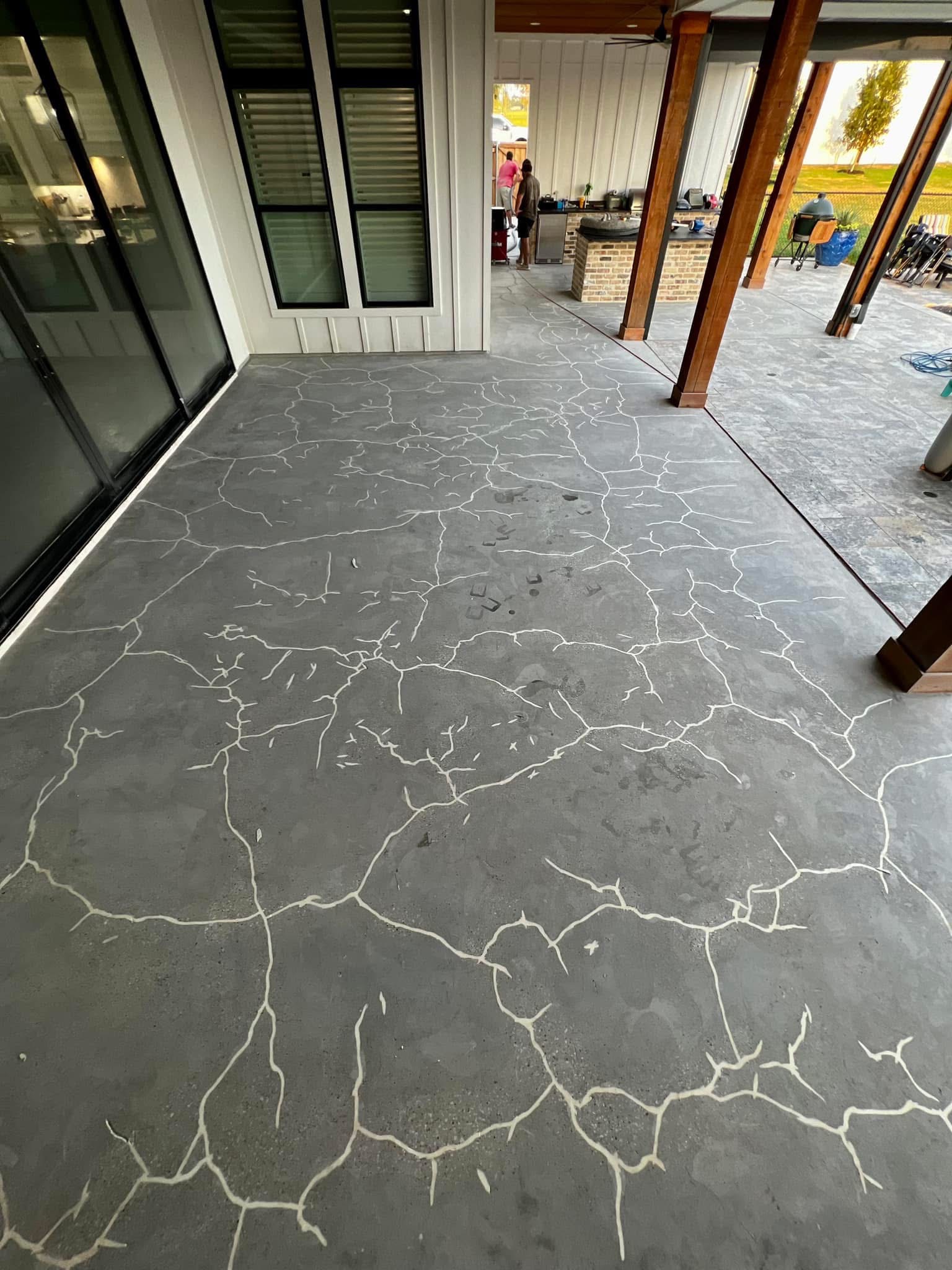Dark gray marbled flake floor coating finished on a covered patio